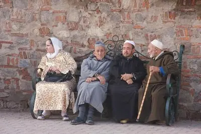 a group of older people sitting on a bench at Riad Safae in Marrakech