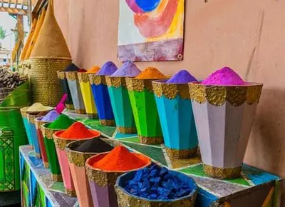 a row of colorful buckets sitting on a shelf at Riad Safae in Marrakech