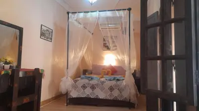 a bedroom with a canopy bed in a room at Riad Jakoura in Marrakech
