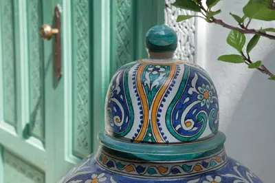 a colorful vase sitting next to a door at Riad Ifoulki in Marrakech