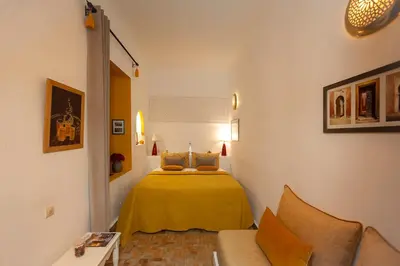 a small bedroom with a bed in a room at Riad Boussa in Marrakech
