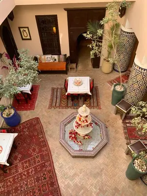 a room with a table and a cake on a floor at Riad Boussa in Marrakech