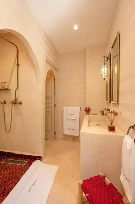 a bathroom with a shower and a sink and a tub at Riad Dar Karma in Marrakech