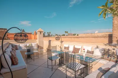 a patio with a table and chairs on a patio at Riad & Spa Azzouz in Marrakech