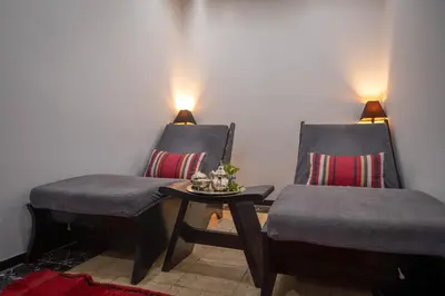 two chairs and a table in a room at Riad & Spa Azzouz in Marrakech
