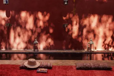 a hat and two candles on a table with fire at Riad Honey in Marrakech
