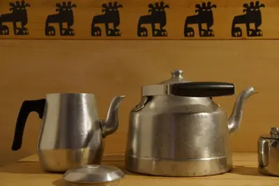 a tea kettle and a cup on a table at Riad Honey in Marrakech
