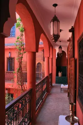 a corridor of a building with a balcony at Riad Honey in Marrakech