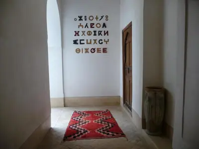 a hallway with a red rug on the floor at Riad Matham in Marrakech
