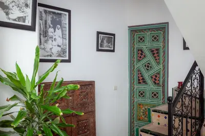a room with a door and a plant next to a staircase at Dar Halima in Marrakech