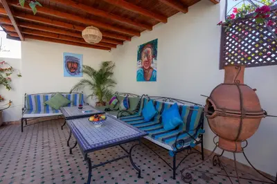 a patio with a table and chairs and a fire hydrant at Dar Halima in Marrakech