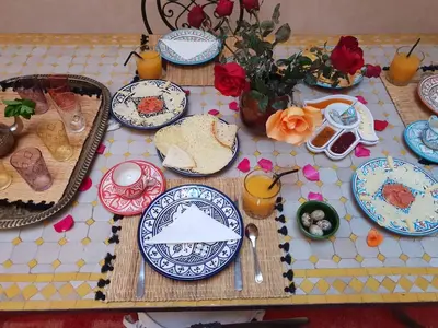 a table with blue and white plates on it at Dar Halima in Marrakech
