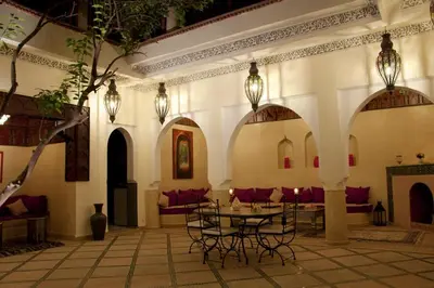 a room with a table and chairs in a building at Riad Granvilier in Marrakech