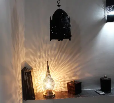 a lamp sitting on a table next to a wall at Riad Alamine in Marrakech