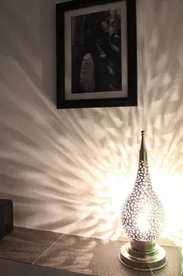 a lamp sitting on a table next to a wall at Riad Alamine in Marrakech