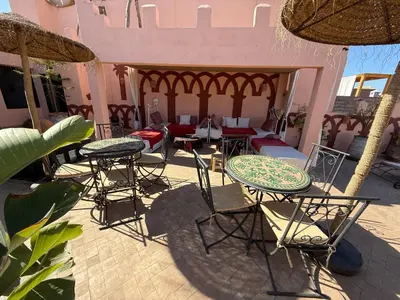 a group of tables and chairs on a patio at Dar Fangui in Marrakech