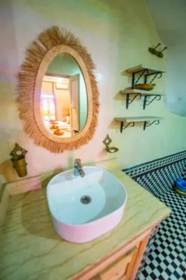 a bathroom with a sink and a mirror at KOUTOBIA ROYAL in Marrakech