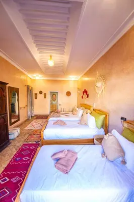 a hotel room with two beds with towels on them at KOUTOBIA ROYAL in Marrakech
