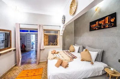 a bedroom with a large white bed in a room at KOUTOBIA ROYAL in Marrakech