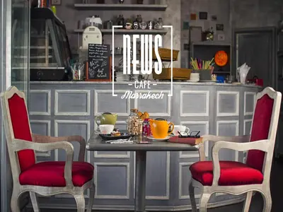 a table with two chairs and a table with food on it at Hotel Lawrence d'Arabie in Marrakech