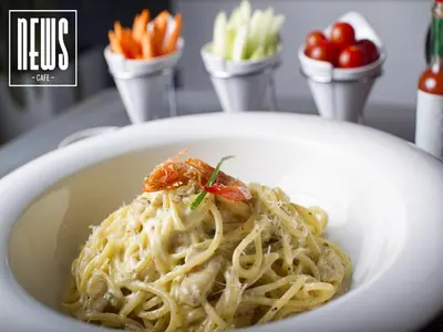 a white bowl of pasta with tomatoes and carrots at Hotel Lawrence d'Arabie in Marrakech