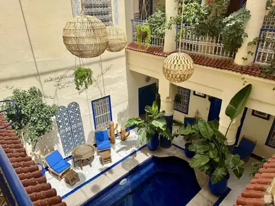 an overhead view of a courtyard with plants and a swimming pool at Riad Hotel Sherazade in Marrakech