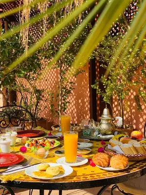 a table with food and drinks on it at Riad Hotel Sherazade in Marrakech