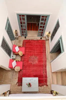an overhead view of a large red rug in a room at Riad Dar Aicha en Exclusivité in Marrakech