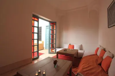 a living room with a couch and a table at Riad Dar Aicha en Exclusivité in Marrakech