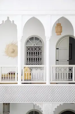 a white wall with shelves with drinks on it at Riad Oriental Glory & Spa in Marrakech