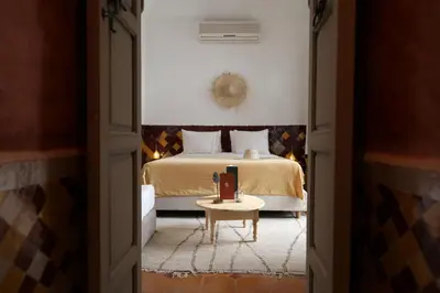 a bedroom with a bed and a table in a room at Riad Oriental Glory & Spa in Marrakech