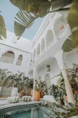 a building with a pool and plants in it at Riad Oriental Glory & Spa in Marrakech