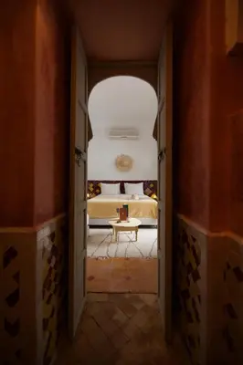 a hallway leading to a bedroom with a bed at Riad Oriental Glory & Spa in Marrakech