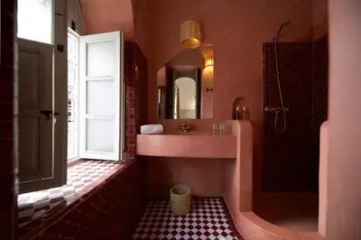 a bathroom with a sink and a shower and a mirror at Riad Oriental Glory & Spa in Marrakech