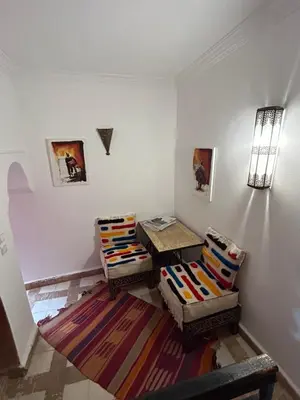a living room with two chairs and a table at Riad N10 in Marrakech