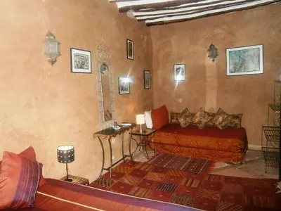 a room with a bed and a table in it at Riad N10 in Marrakech