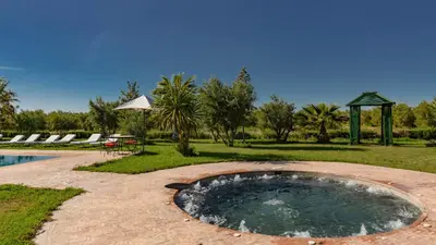 a small pool of water on a brick patio at L'OLIVERAIE DE L'ATLAS in Marrakech