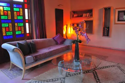 a living room with a couch and a glass table at Casa Taos in Marrakech