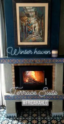 a fireplace with a painting on top of it at Casa Taos in Marrakech