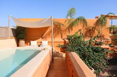 a resort with a swimming pool and a building at Dar Akal in Marrakech
