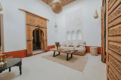 a living room with a table and a couch at Dar Akal in Marrakech