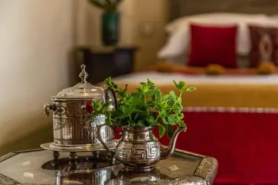 a table with a tea pot and flowers on it at Riad Smara in Marrakech