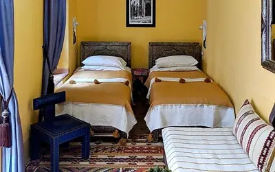 a room with two beds and a couch at Riad Smara in Marrakech