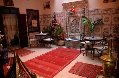 a room with tables and chairs and a christmas tree at Dar LEULEU in Marrakech