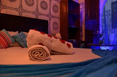 a close up of a bed with a towel on it at Dar LEULEU in Marrakech