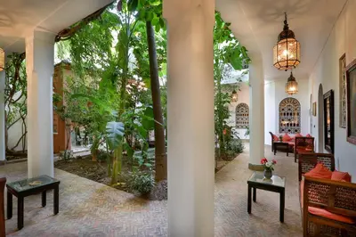 a lobby of a house with trees and plants at Riad Dar El Assafir in Marrakech