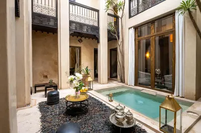 a courtyard with a swimming pool in a building at Riad Vanilla Sma & Spa in Marrakech