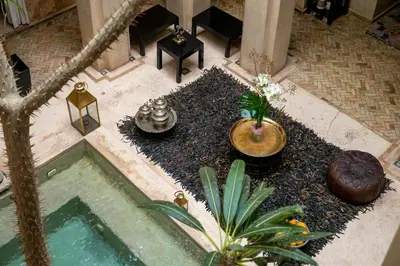 an overhead view of a pool with plants and a table at Riad Vanilla Sma & Spa in Marrakech