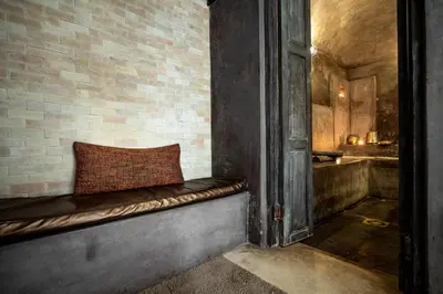 a bench with a pillow on a brick wall at Riad Vanilla Sma & Spa in Marrakech