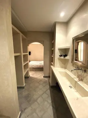 a bathroom with a sink and a bed in a room at Riad Kasbah 117 in Marrakech